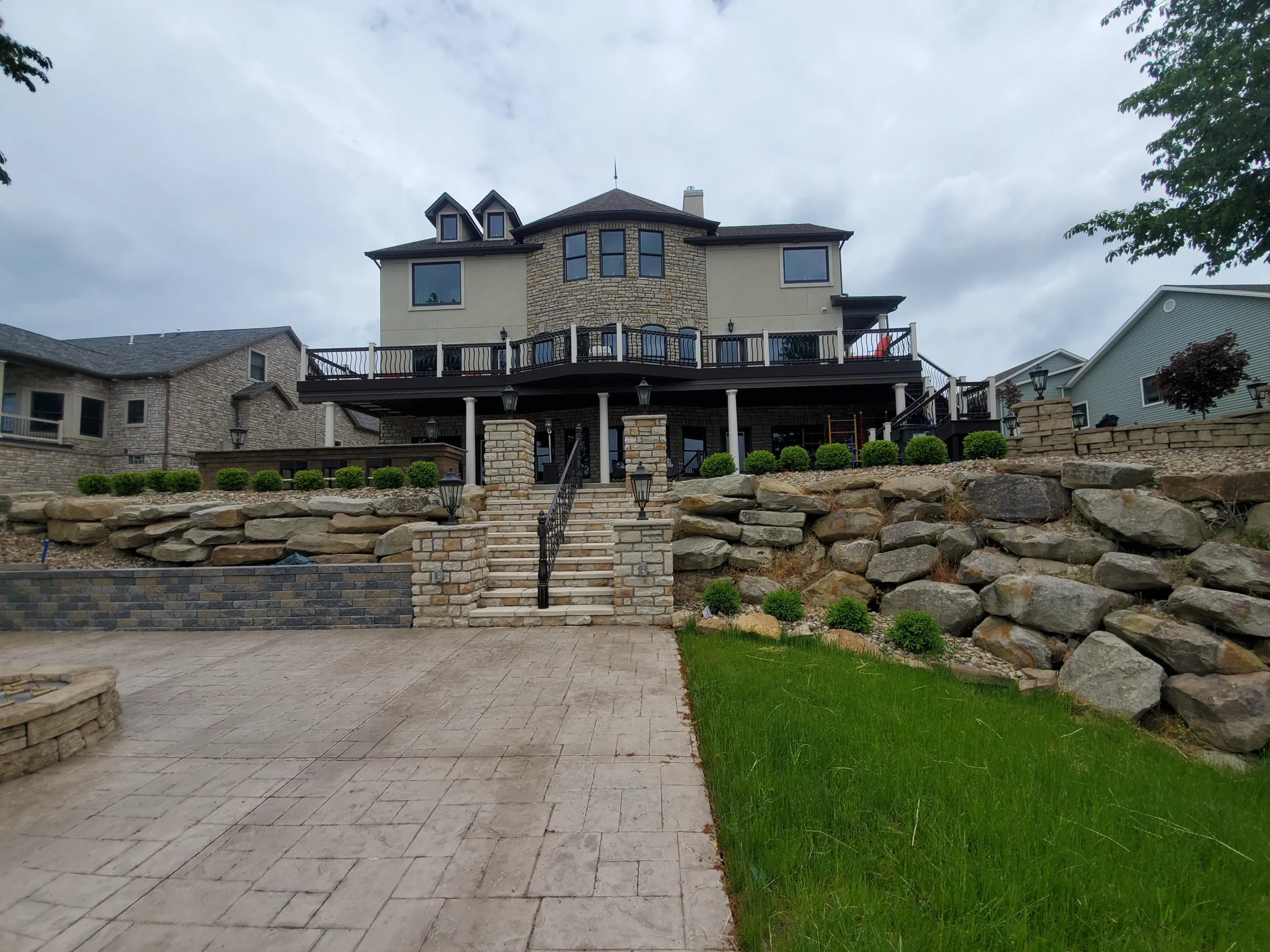 Custom hardscaping installation with stone walls, pavers, and outdoor features