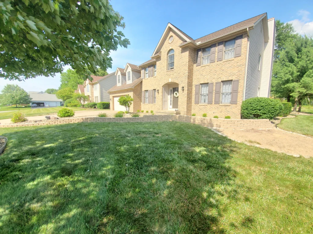 Professional landscaping with lawn, plants, and outdoor design features