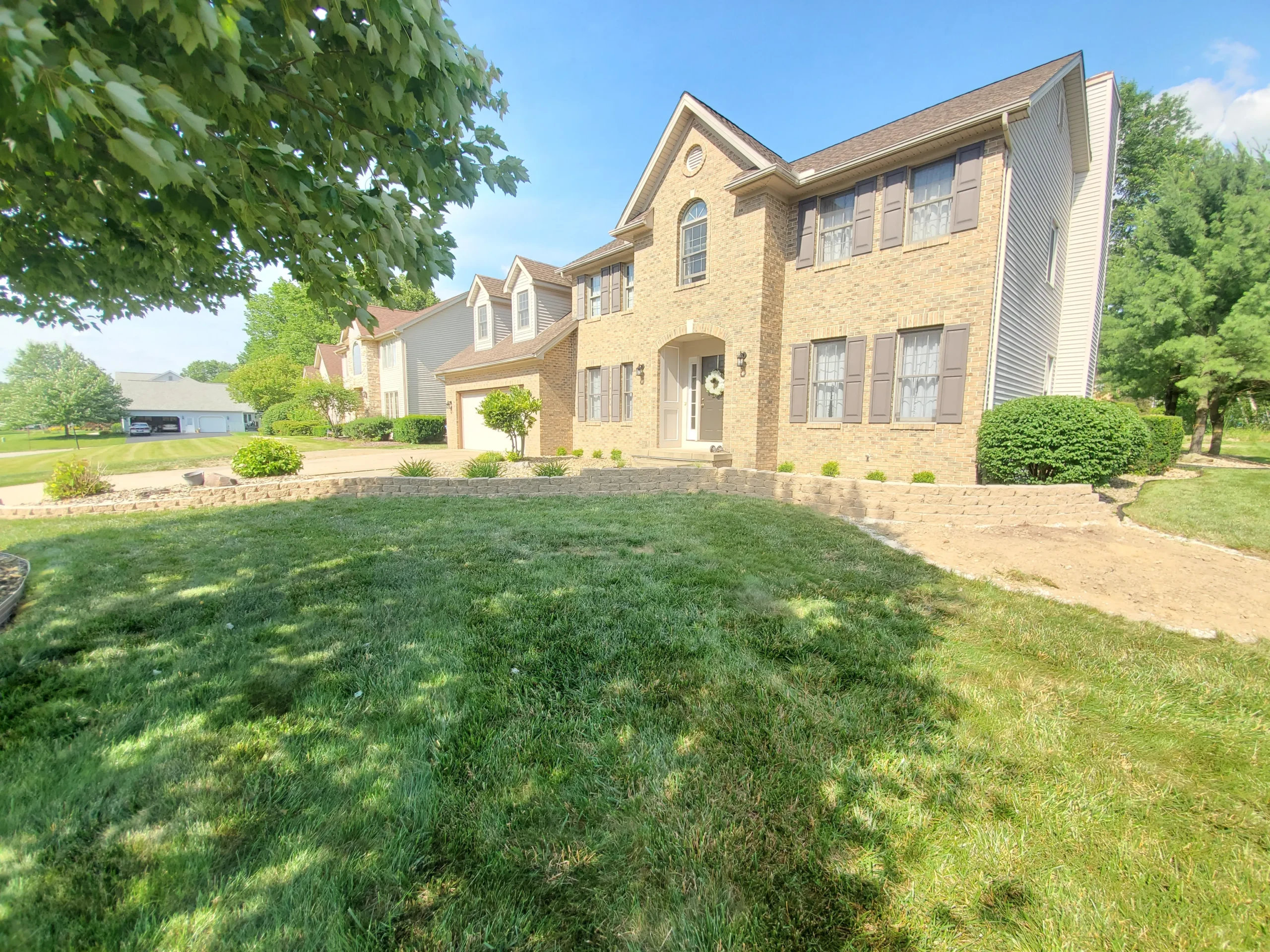 Professional landscaping with lawn, plants, and outdoor design features