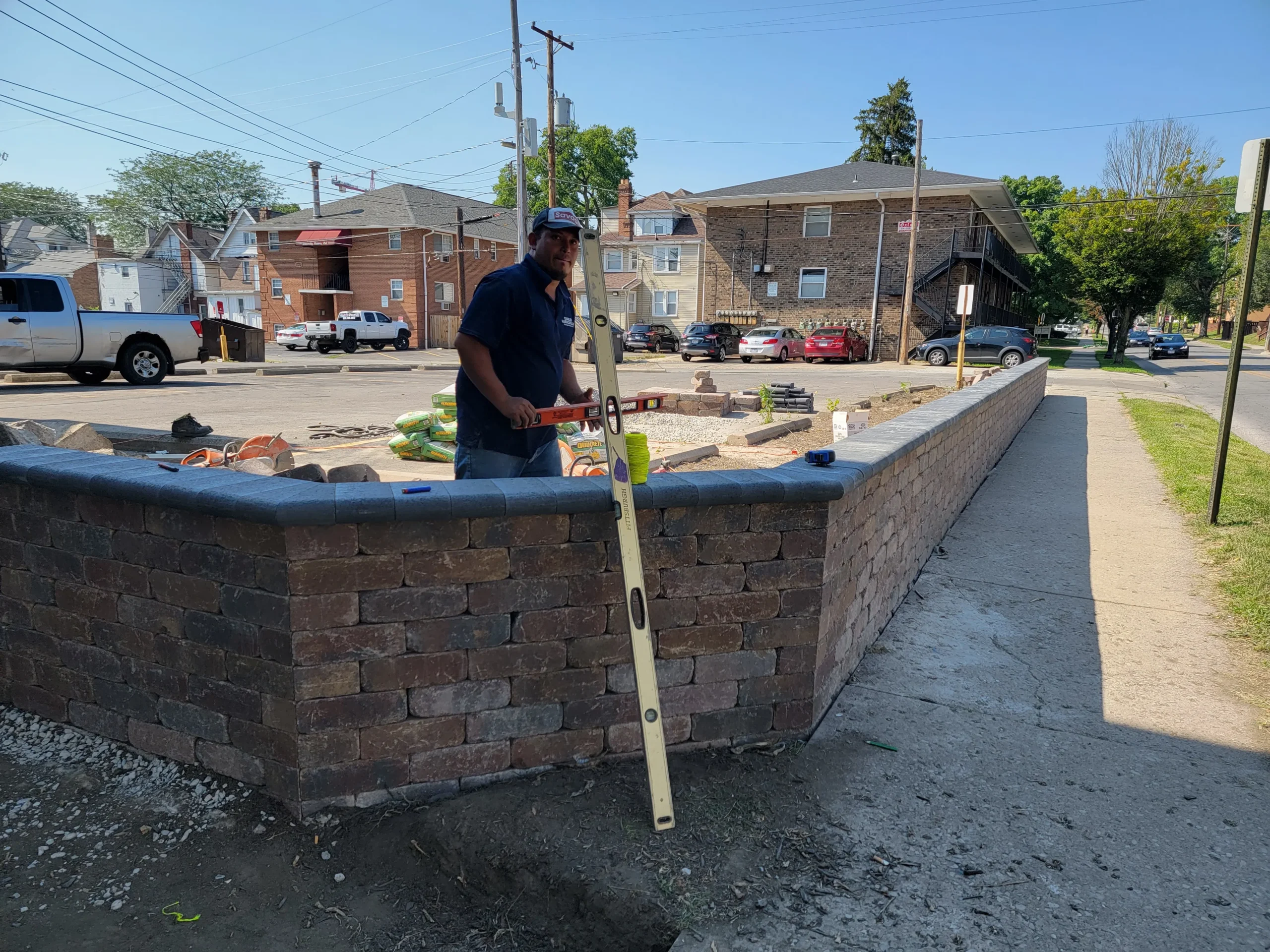 Custom hardscaping installation with stone walls, pavers, and outdoor features