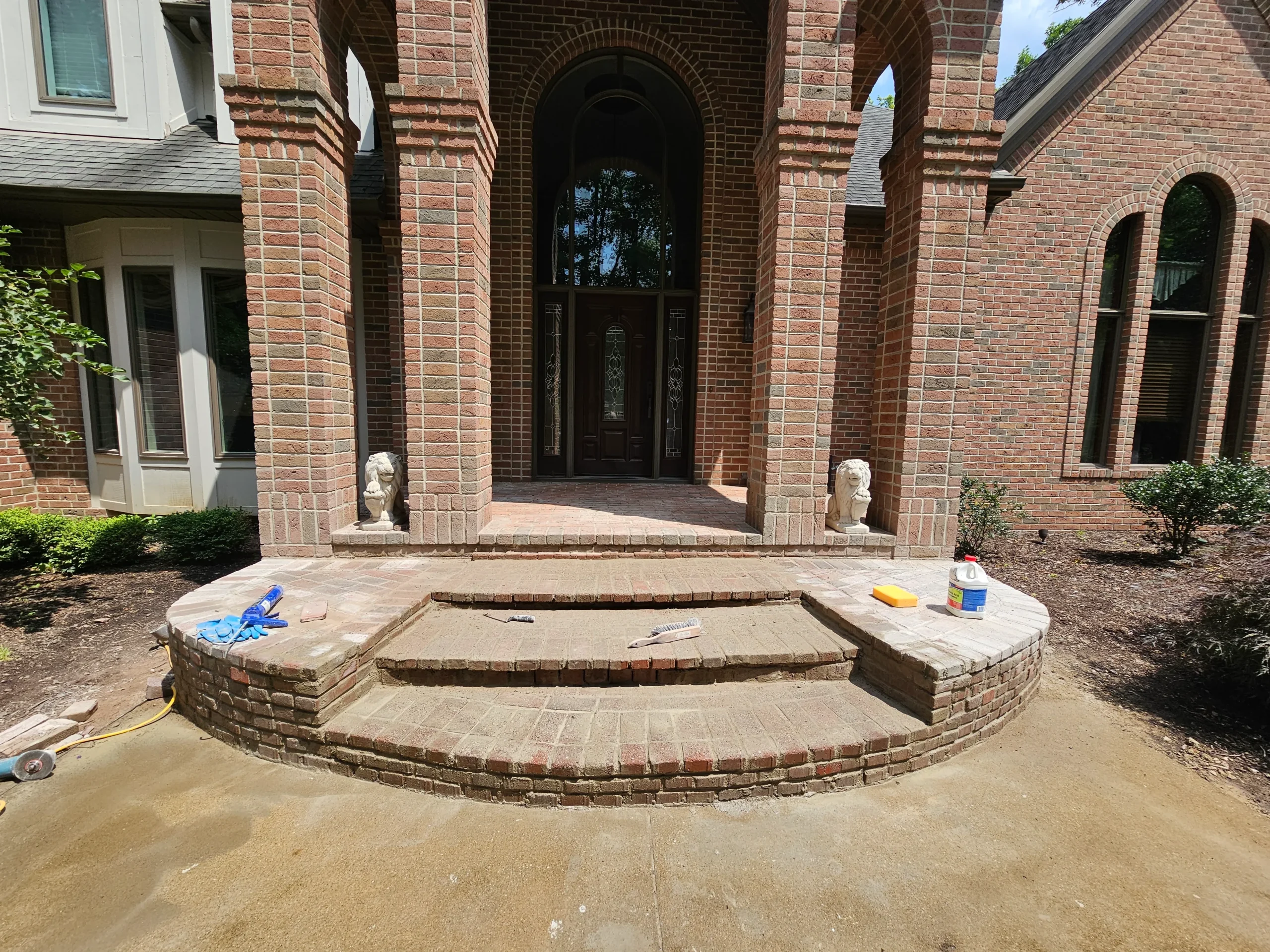 Custom hardscaping installation with stone walls, pavers, and outdoor features