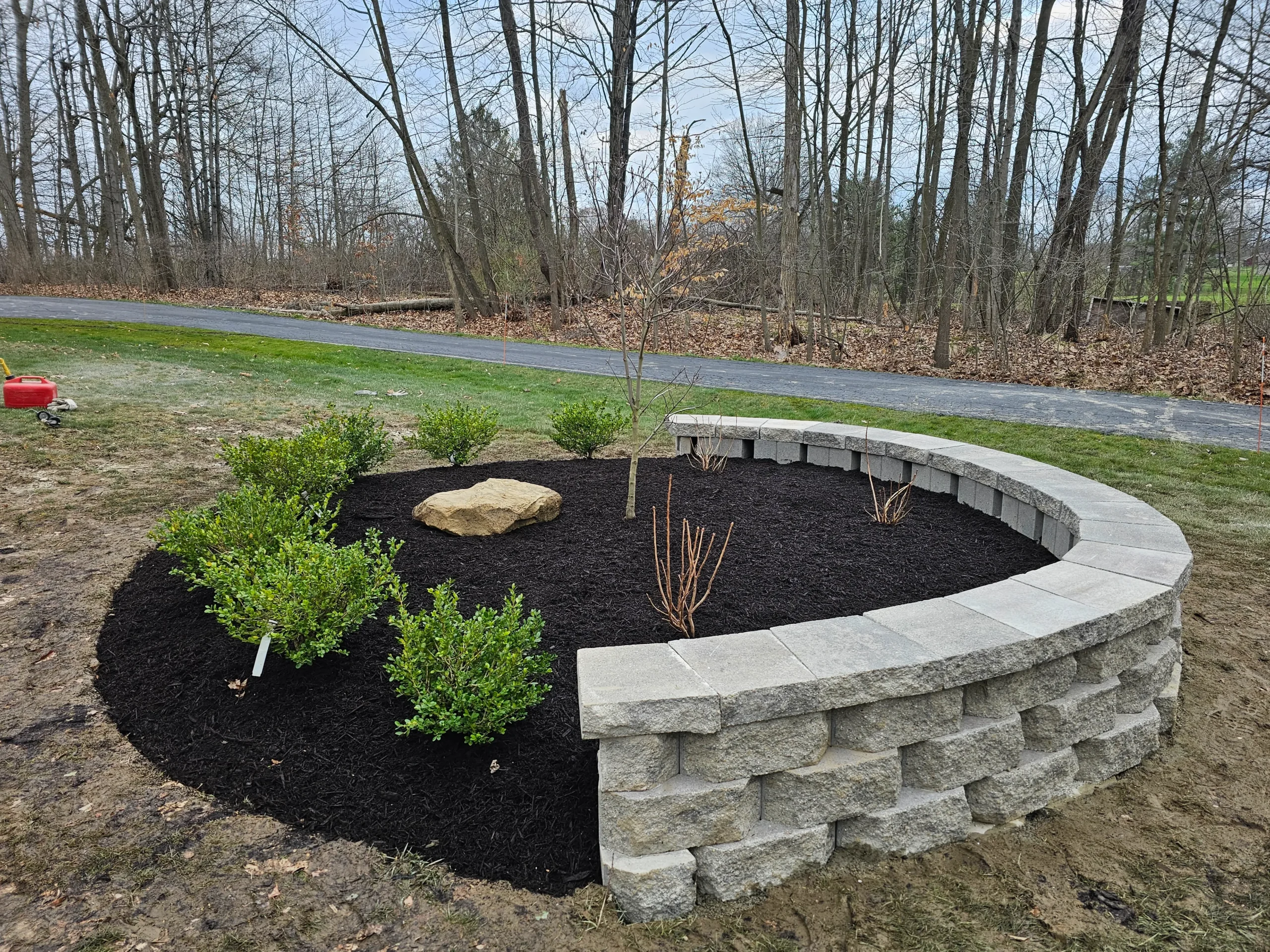 Custom outdoor patio installation with pavers and stone design