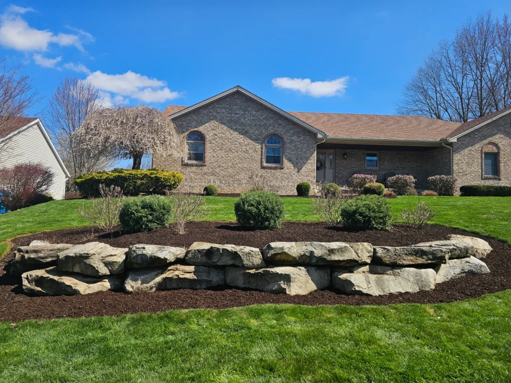 Custom hardscaping installation with stone walls, pavers, and outdoor features