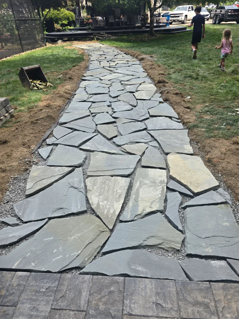 Professional landscaping with lawn, plants, and outdoor design features