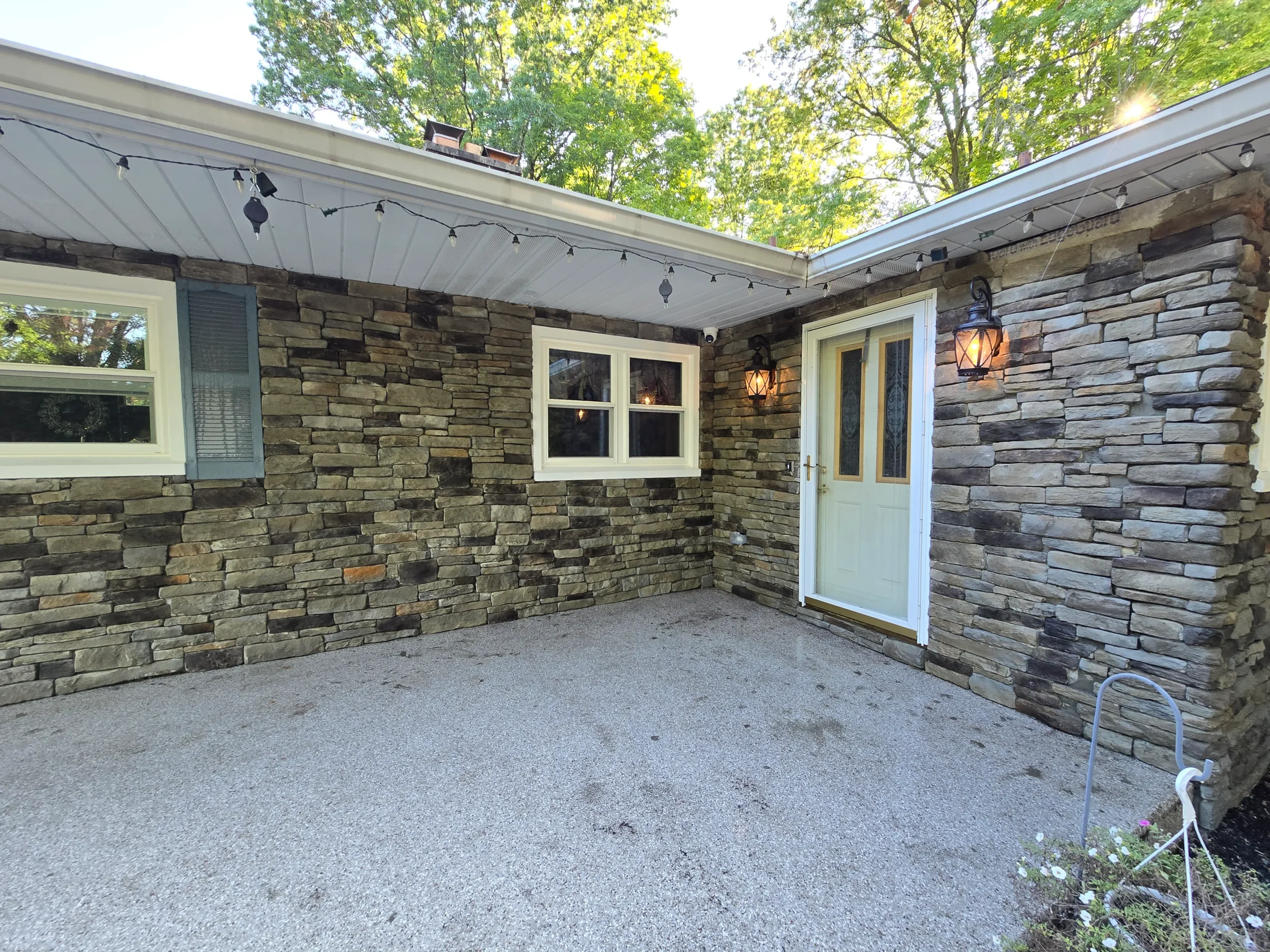 Custom hardscaping installation with stone walls, pavers, and outdoor features