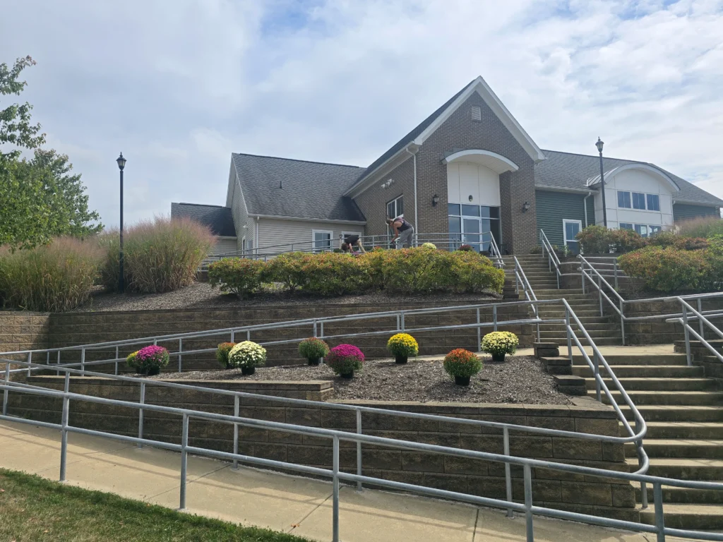 Professional landscaping with lawn, plants, and outdoor design features