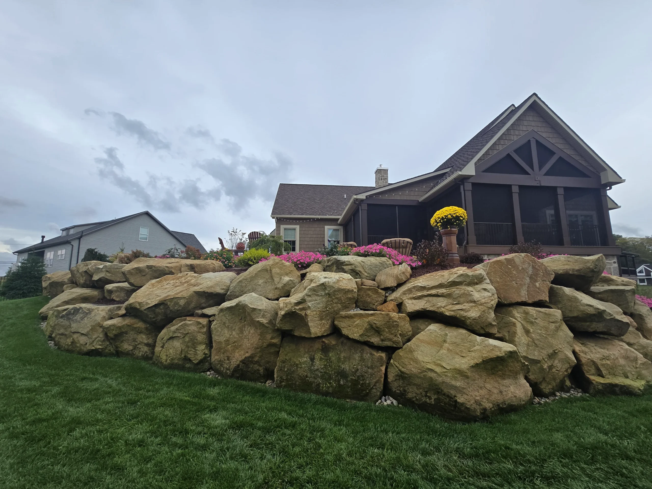 Custom hardscaping installation with stone walls, pavers, and outdoor features