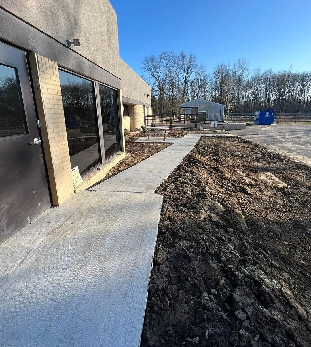 Professional landscaping with lawn, plants, and outdoor design features